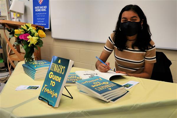 Karisma Jaini signs copies of A Teenager's Guide to Feminism.